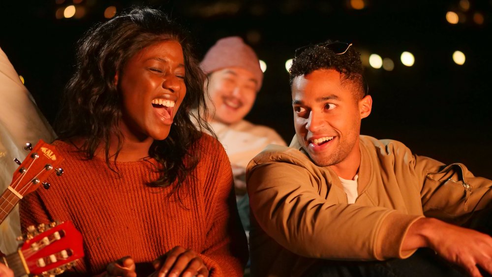 man talking to a woman with a big smile